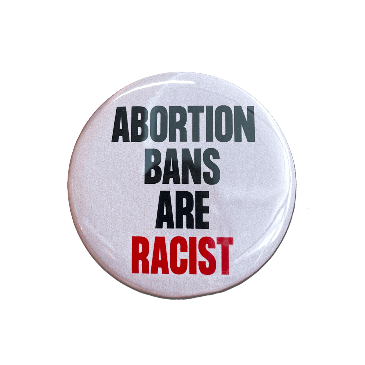 White button that says abortion bans are racist in black and red