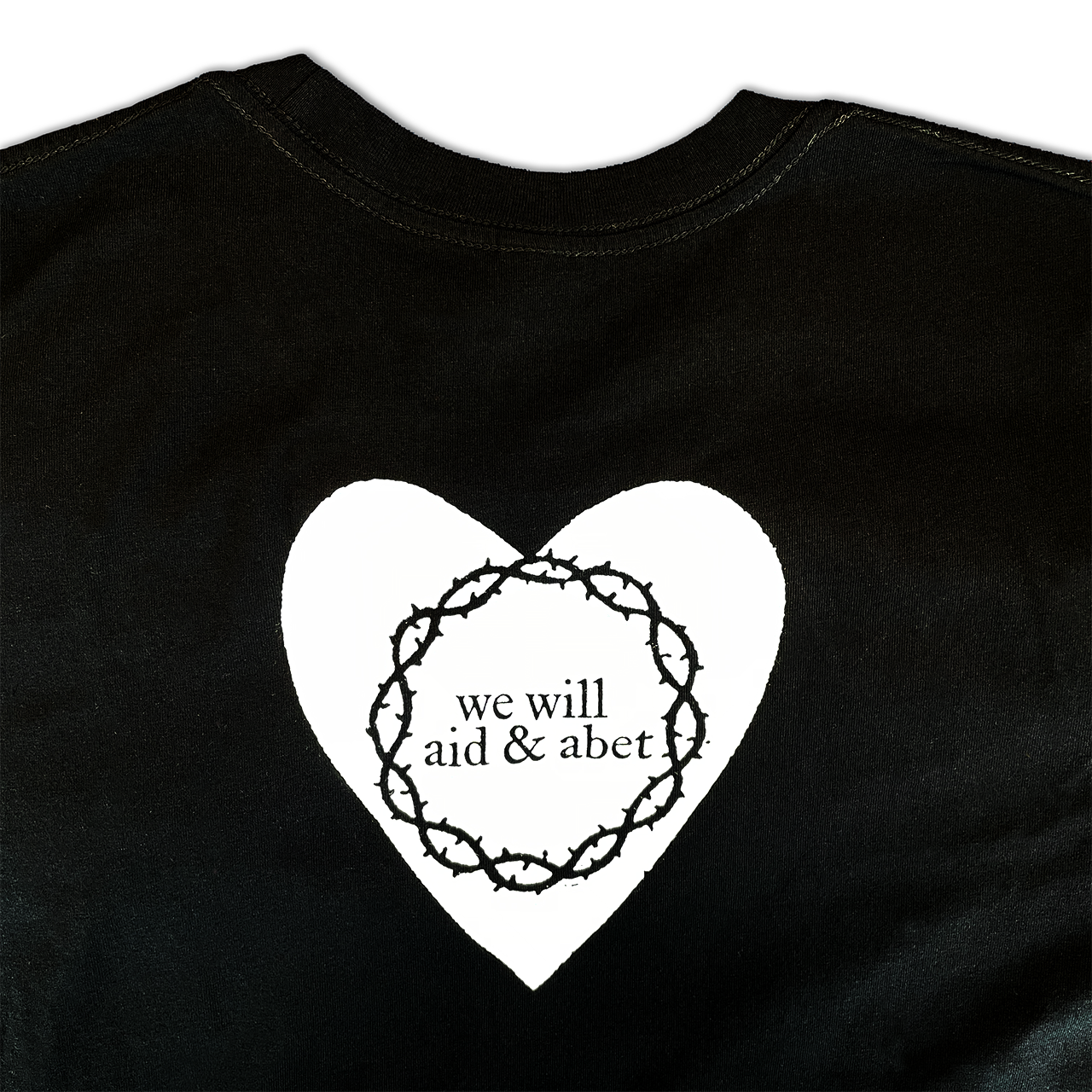 Black of black tee with a white heart, barb wire circle and reads 