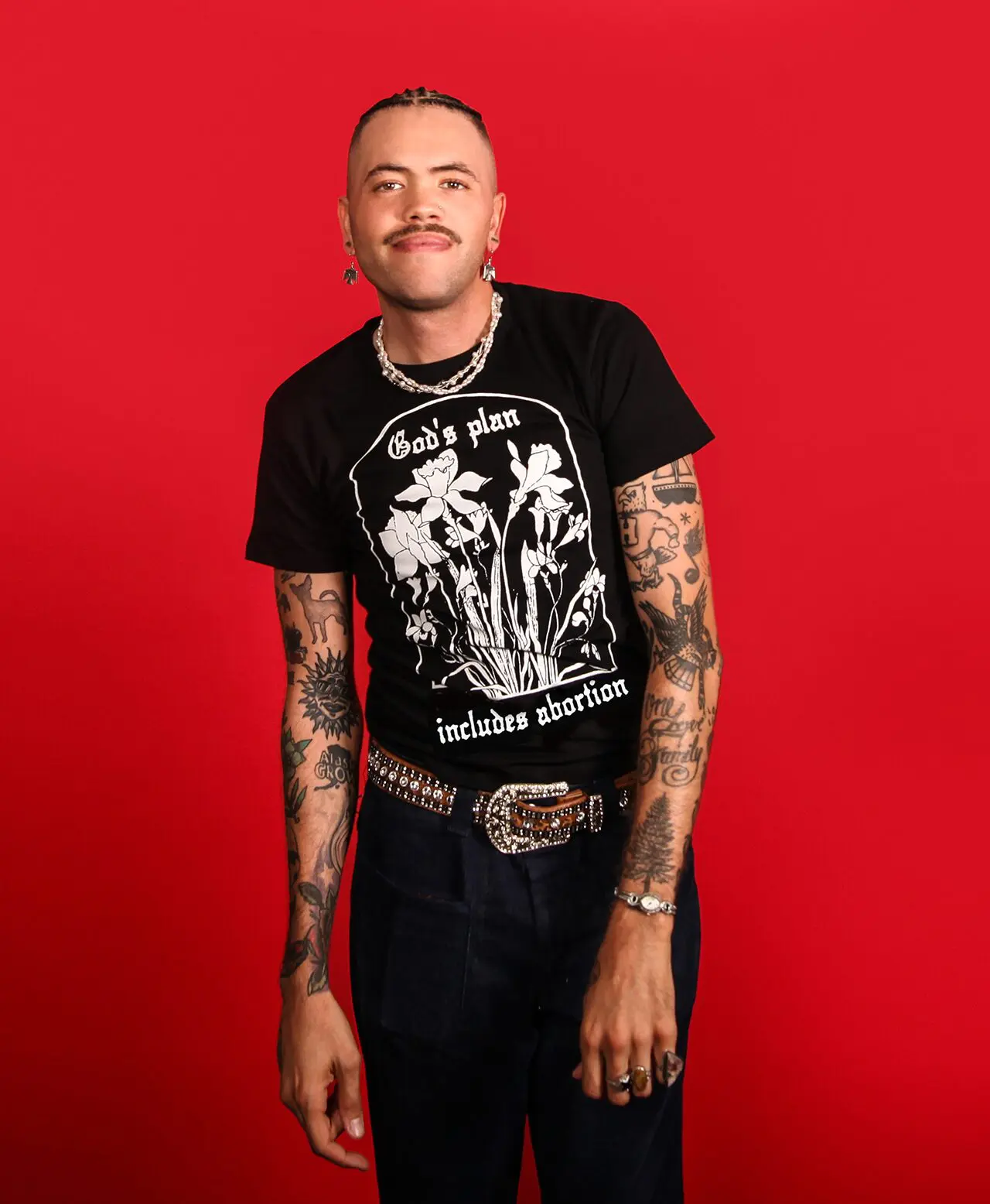 Model wearing a black tee that says 