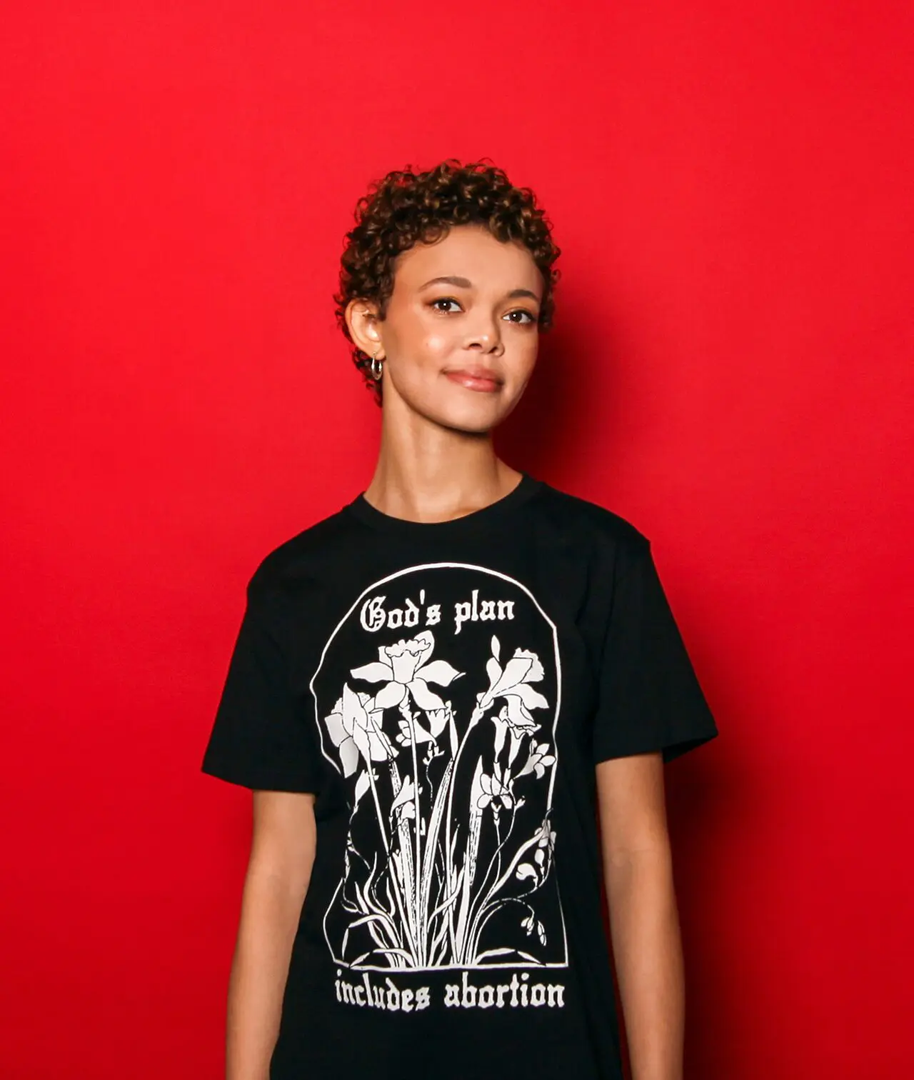 Model wearing a black tee that says 