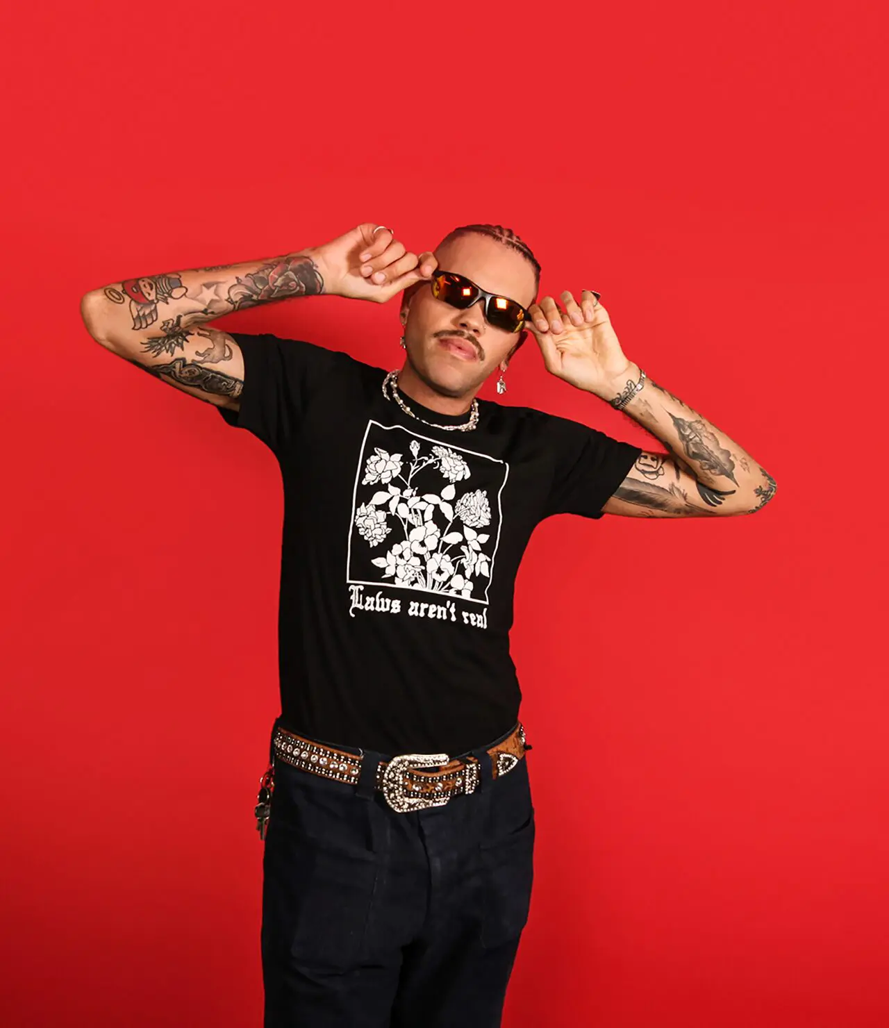 Model wearing a black tee that says 