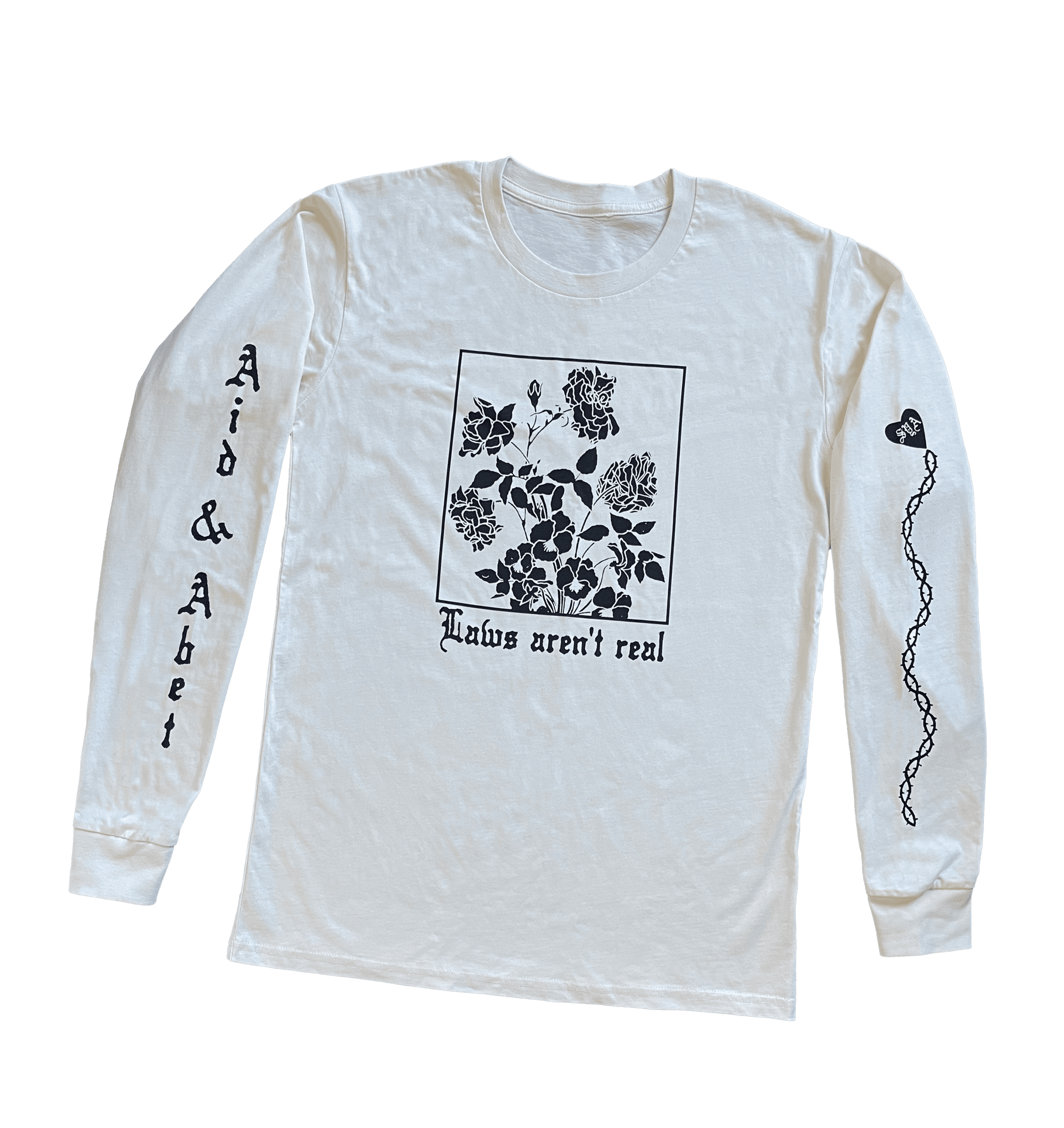 White long sleeve law's aren't real tshirt with drawing of flower and aid and abet on one sleeve with an SYA heart and chain on the other sleeve