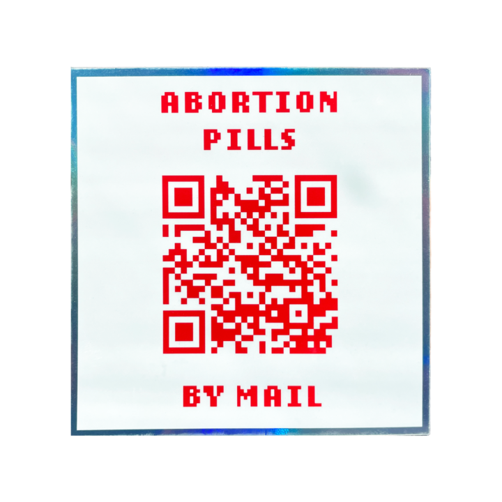 white holographic sticker that says abortion pills by mail with a QR code