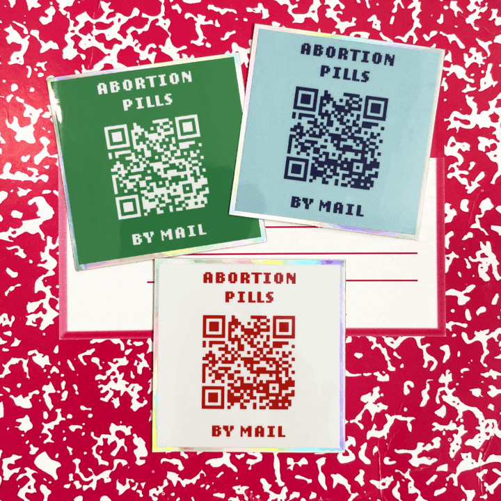 holographic stickers that says abortion pills by mail with a QR code