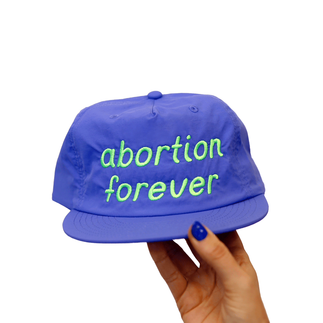 A hand holding a blue hat that says "abortion forever" in green