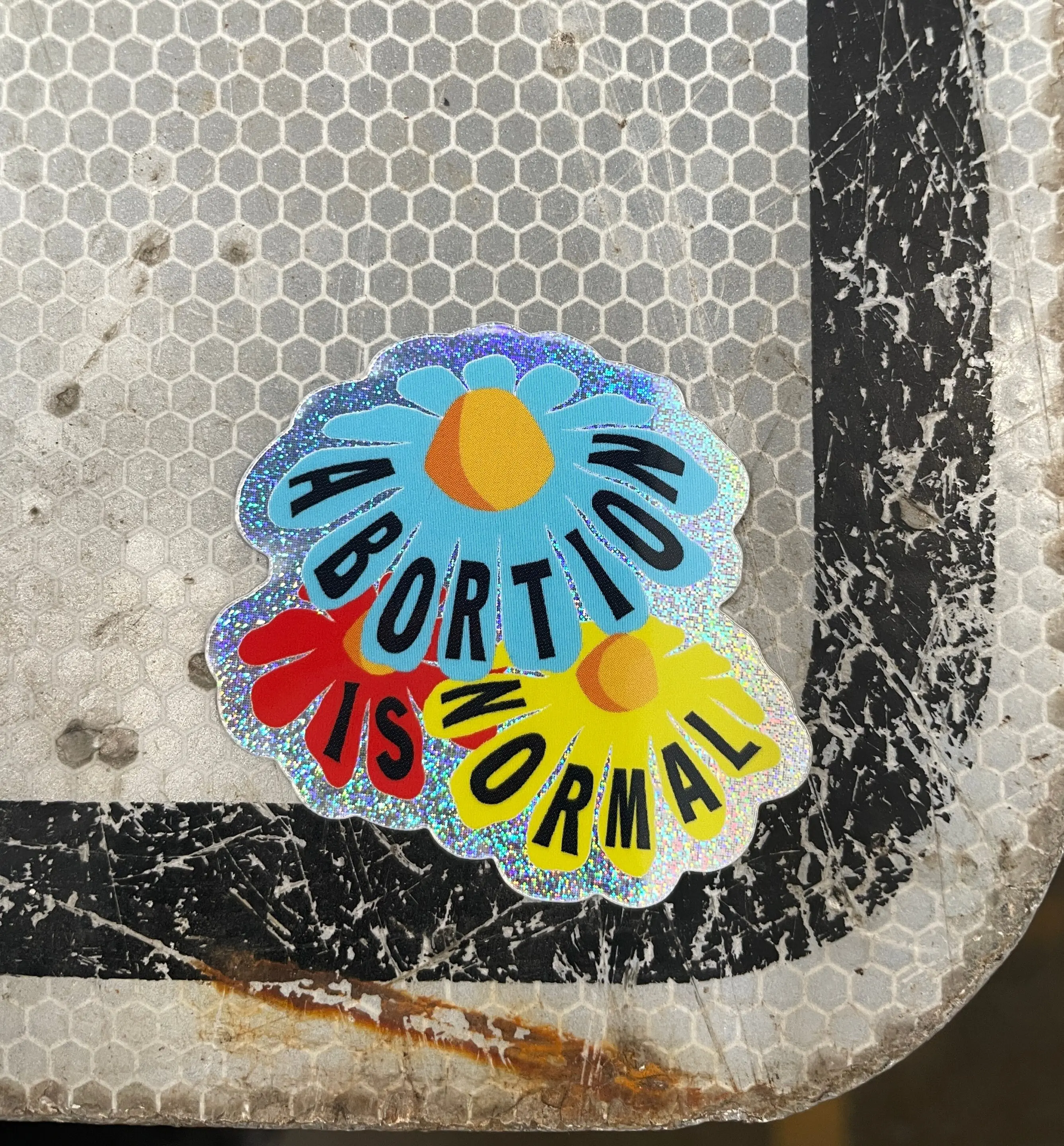 Abortion is Normal flower design holographic sticker on a sign