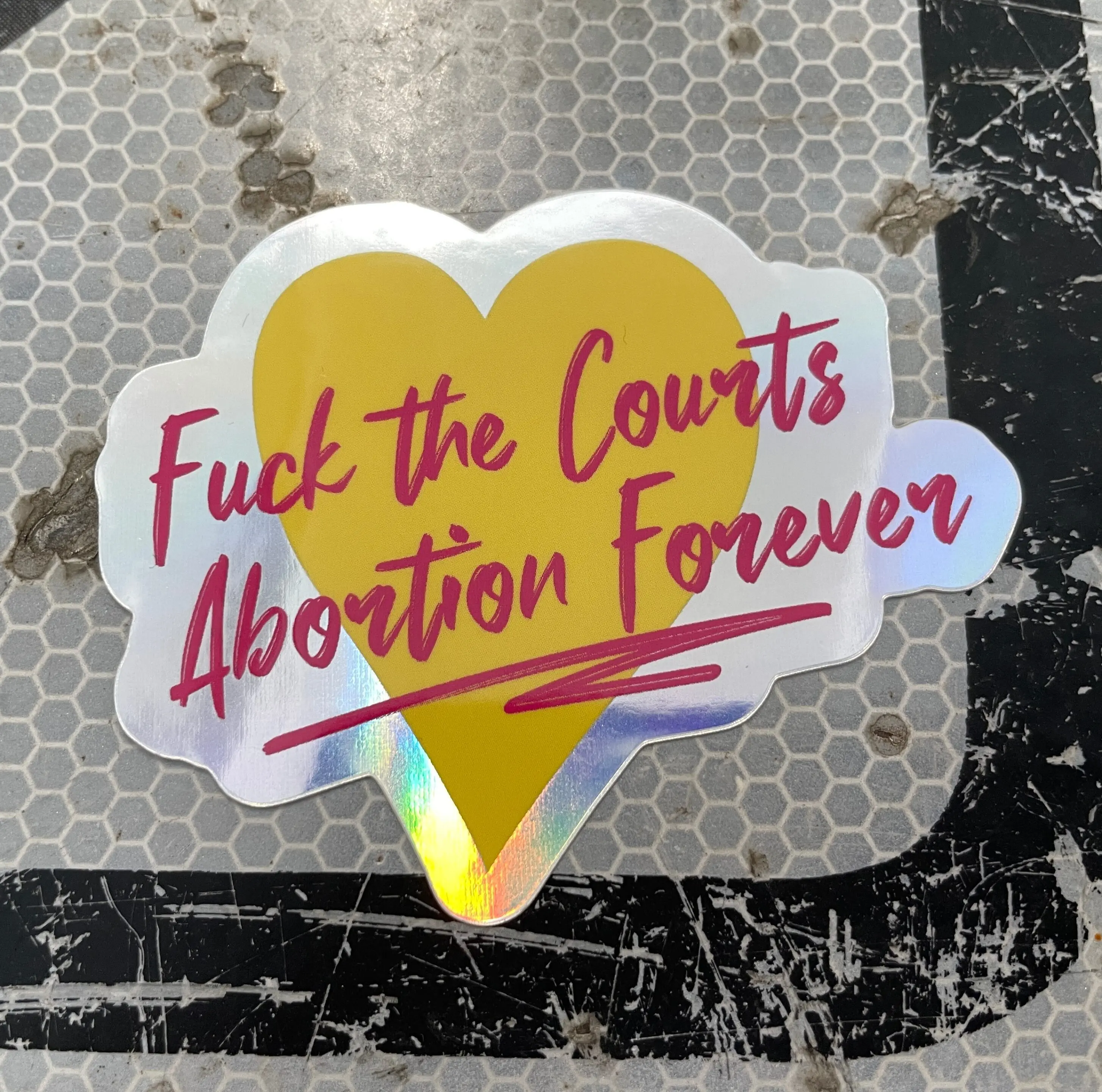 Fuck the Courts, Abortion Forever heart holographic sticker on a sign