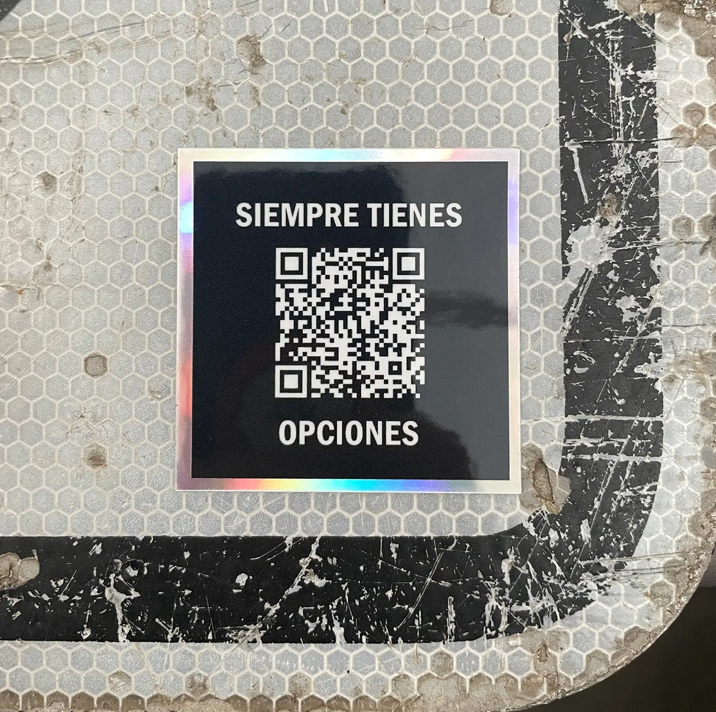 Siempre Tienes Opciones holographic sticker on a sign
